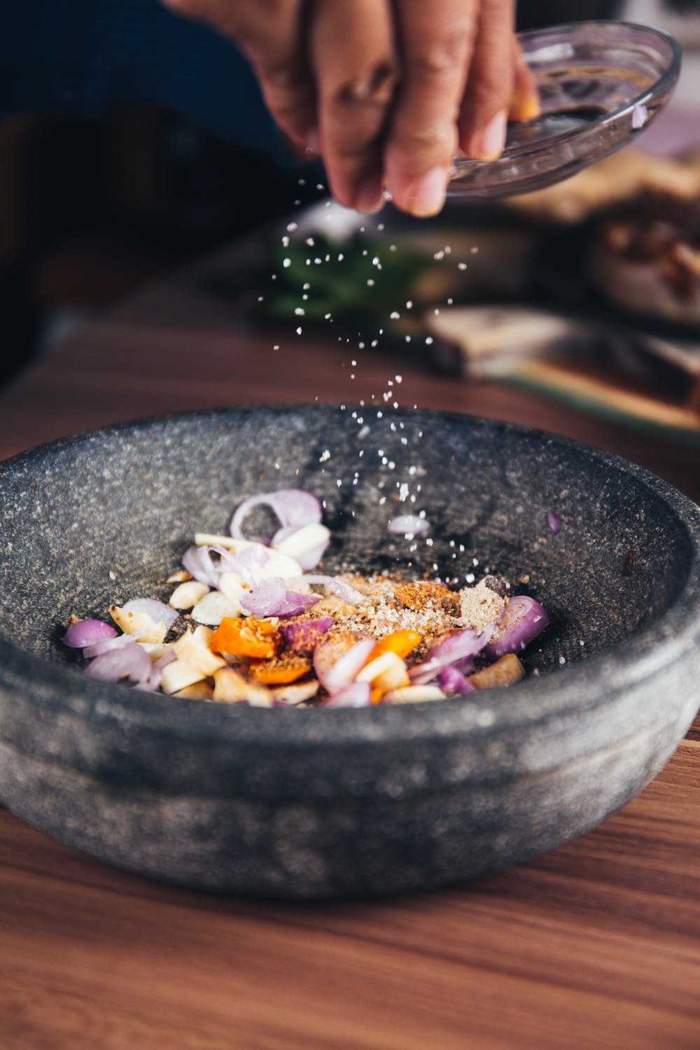 Person pouring salt in a bowl