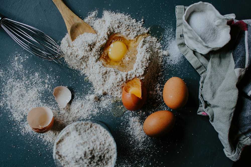 Eggs on a cutting board with some flour